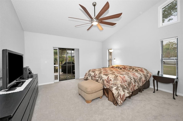 carpeted bedroom with multiple windows, high vaulted ceiling, access to exterior, and ceiling fan