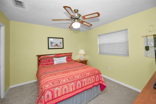 bedroom featuring carpet floors, a textured ceiling, and ceiling fan