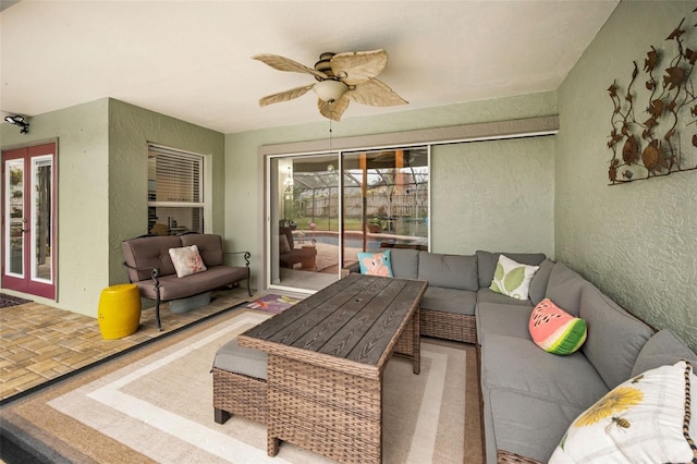 living room with ceiling fan and french doors