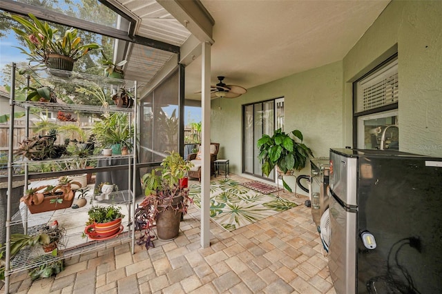 sunroom featuring ceiling fan