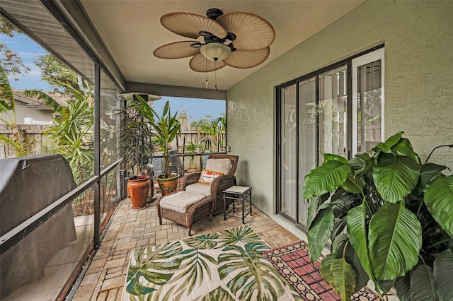 sunroom featuring ceiling fan