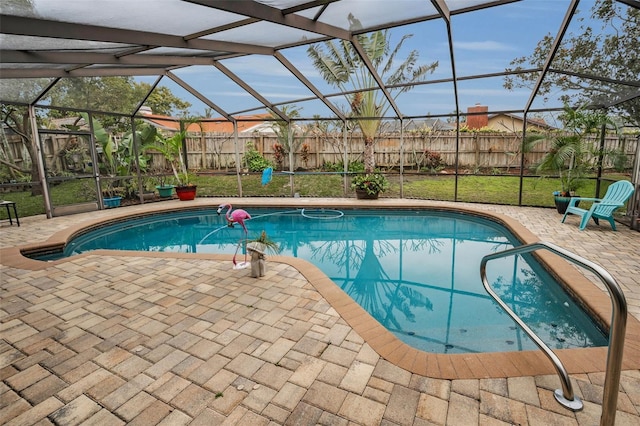 view of swimming pool with a yard, a lanai, and a patio area