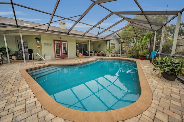 view of pool with a patio, french doors, and glass enclosure