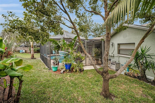 view of yard featuring a lanai and a fenced in pool