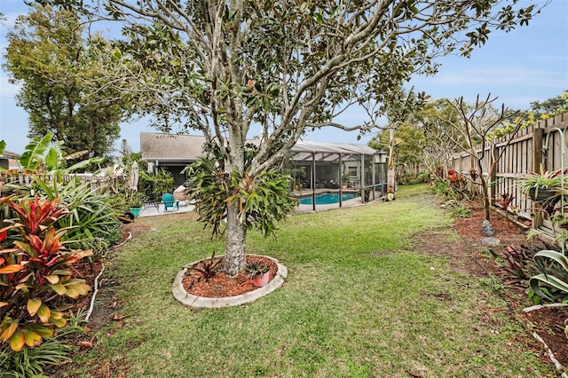 view of yard featuring a fenced in pool and a lanai