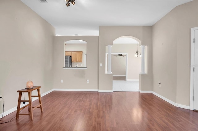 empty room with wood-type flooring and ceiling fan