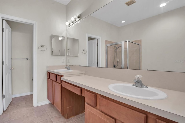 bathroom with vanity, an enclosed shower, and tile patterned flooring