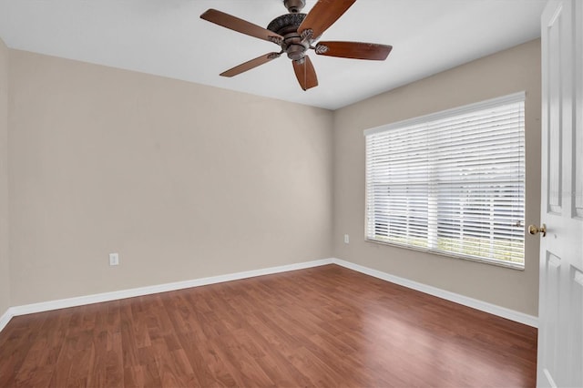 unfurnished room with dark hardwood / wood-style floors and ceiling fan