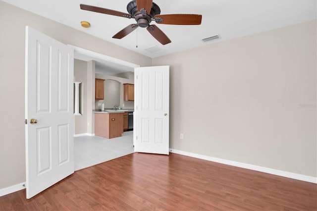 spare room featuring ceiling fan and light wood-type flooring