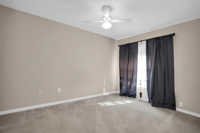 carpeted empty room featuring ceiling fan