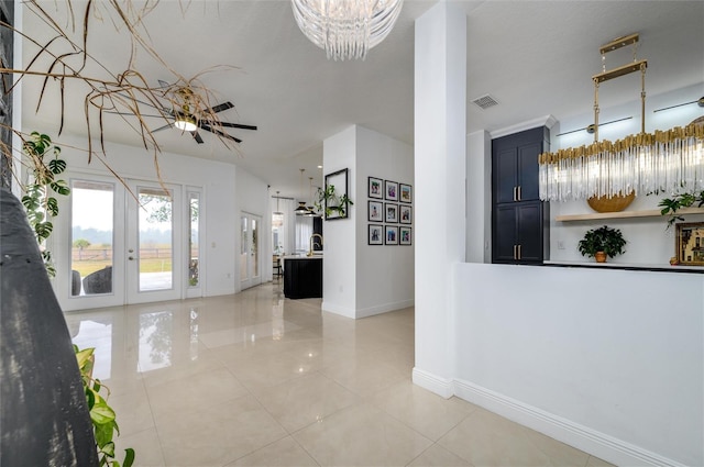 entrance foyer featuring light tile patterned floors and a chandelier