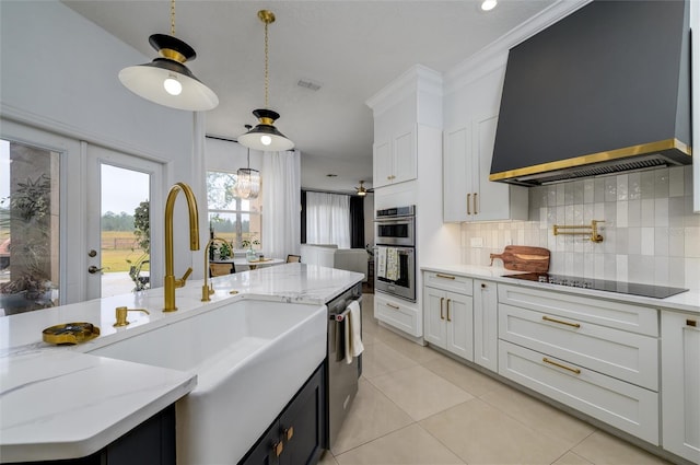 kitchen with tasteful backsplash, appliances with stainless steel finishes, sink, and white cabinets