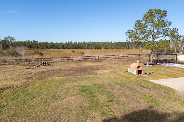 view of yard with a carport and a rural view