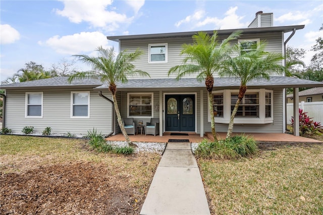 view of front of house with a porch and a front lawn