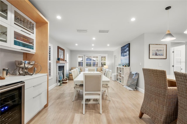 dining room with beverage cooler and light wood-type flooring