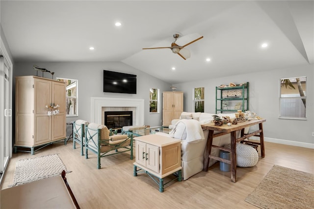 living room featuring vaulted ceiling, ceiling fan, and light hardwood / wood-style flooring