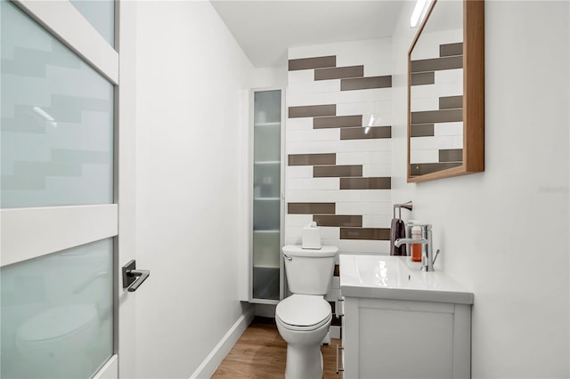 bathroom featuring vanity, toilet, and hardwood / wood-style floors