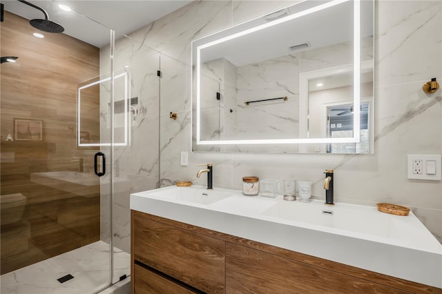 bathroom with vanity, ceiling fan, and a shower with shower door