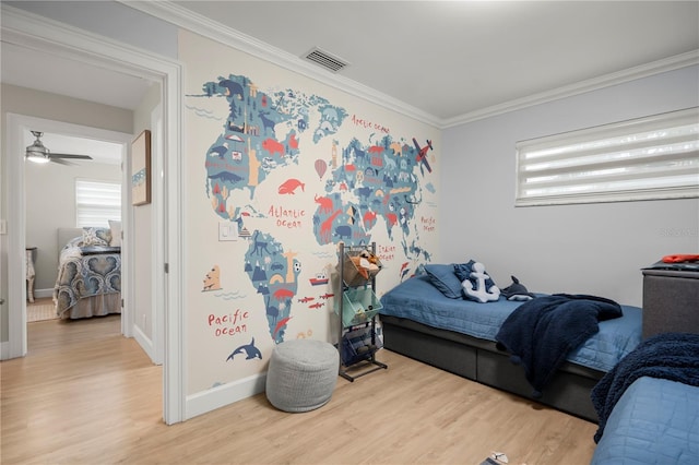 bedroom featuring hardwood / wood-style floors and crown molding