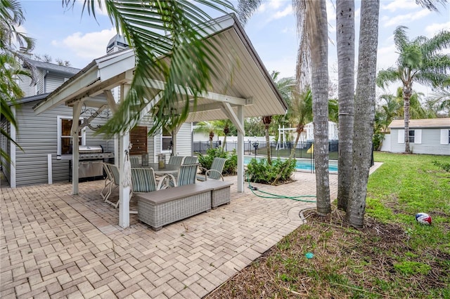 view of patio featuring an outbuilding and a fenced in pool