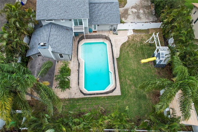 view of swimming pool with a lawn