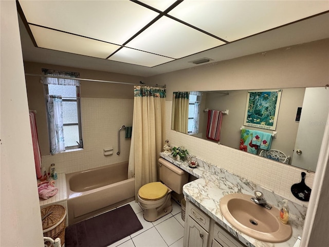 full bathroom featuring tile patterned flooring, shower / tub combo, backsplash, vanity, and toilet