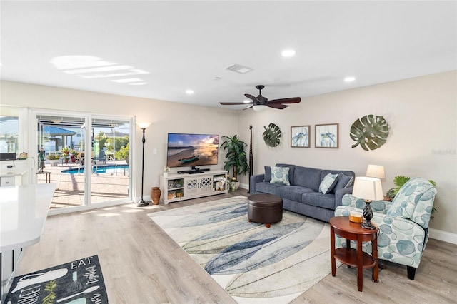 living room featuring light hardwood / wood-style flooring and ceiling fan