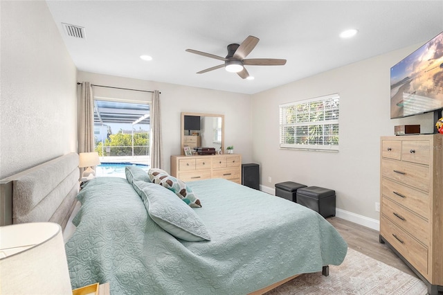 bedroom featuring multiple windows, light wood-type flooring, and ceiling fan