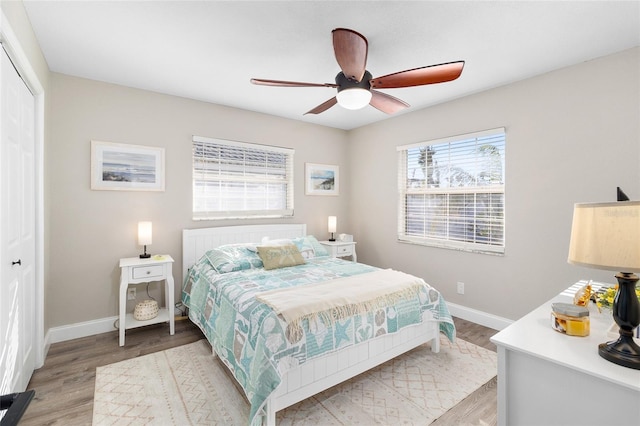 bedroom featuring light hardwood / wood-style flooring, a closet, and ceiling fan