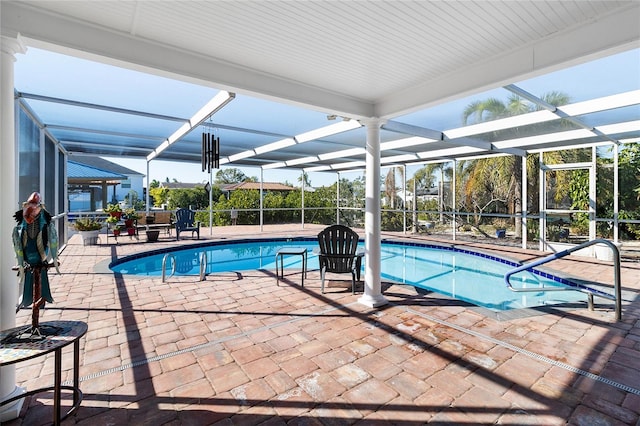 view of swimming pool with a patio and a lanai