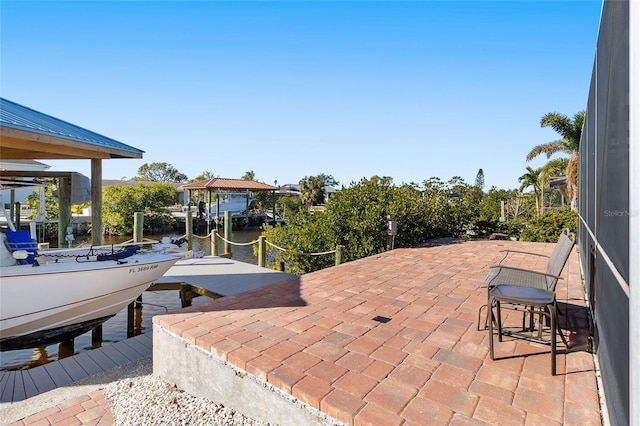 view of patio / terrace with a water view and a boat dock