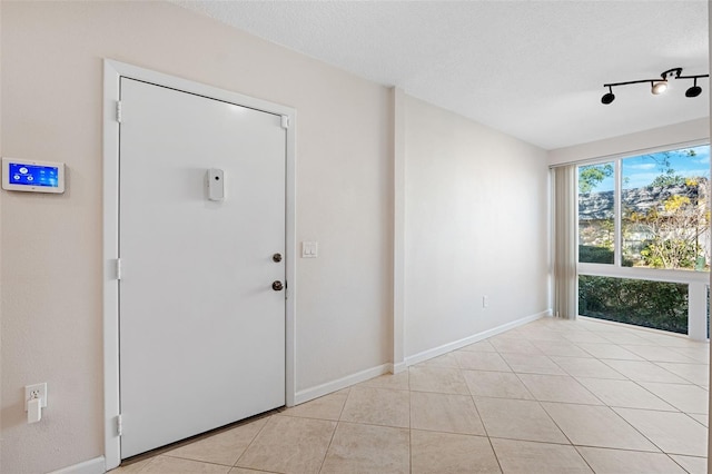 tiled entrance foyer with a textured ceiling