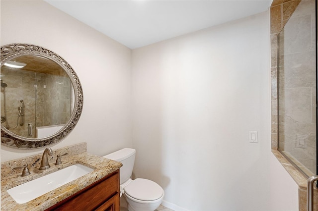 bathroom featuring vanity, a shower with shower door, and toilet