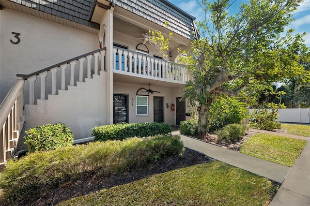 property entrance with ceiling fan and a balcony