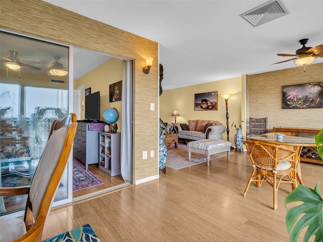 interior space with wood finished floors, visible vents, and a ceiling fan