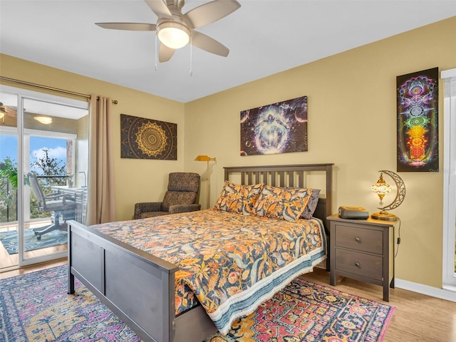 bedroom with access to exterior, a ceiling fan, baseboards, and wood finished floors