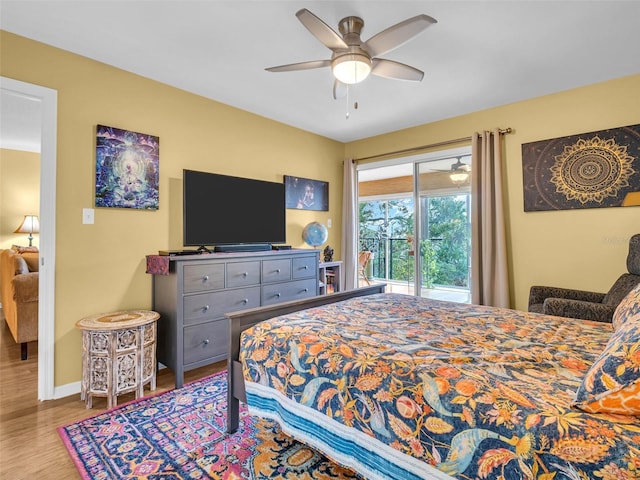 bedroom with a ceiling fan, access to outside, baseboards, and wood finished floors