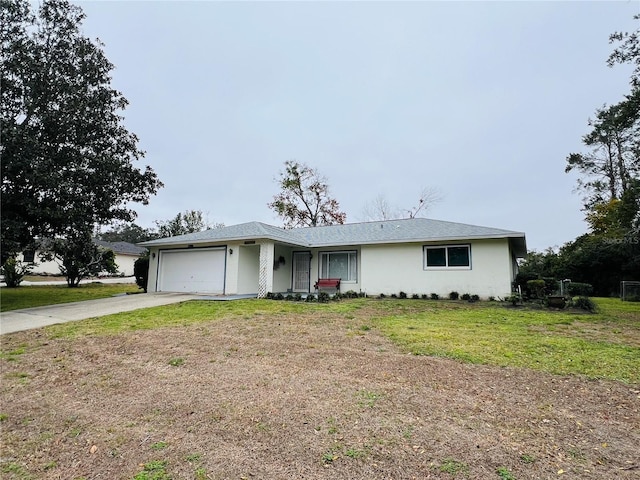 single story home featuring a garage and a front lawn