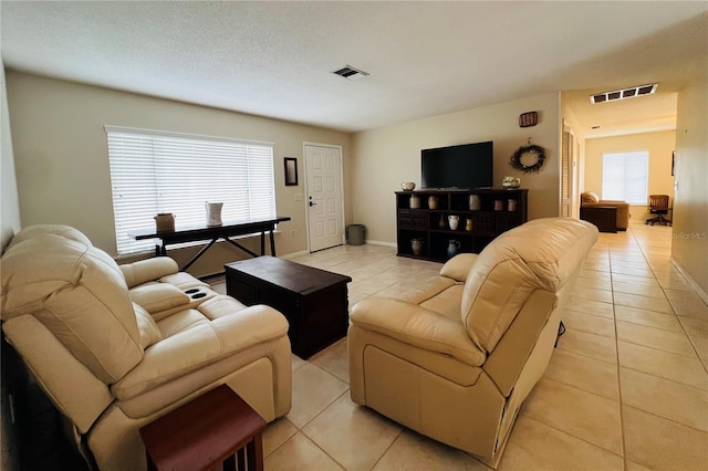 tiled living room with plenty of natural light