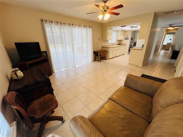 living room with light tile patterned floors and ceiling fan