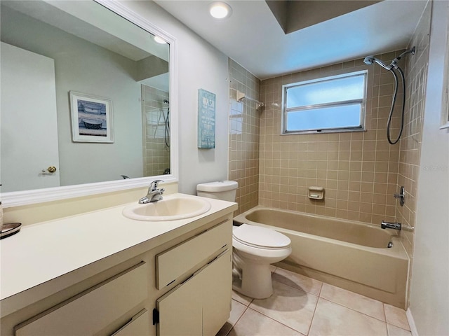 full bathroom featuring vanity, tiled shower / bath combo, tile patterned floors, and toilet