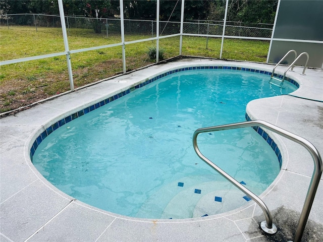 view of pool with a lawn