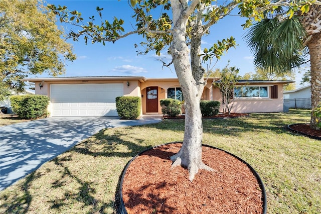 single story home featuring a garage and a front lawn