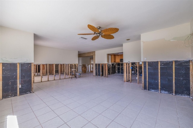 empty room with light tile patterned floors and ceiling fan