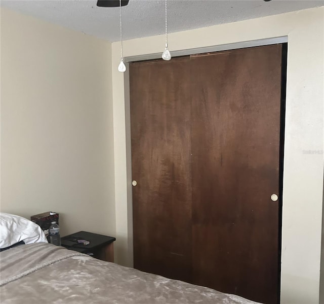 bedroom with a closet and a textured ceiling