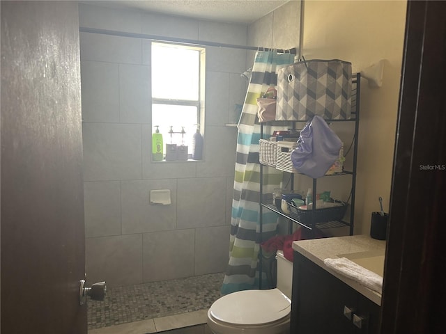 bathroom with vanity, curtained shower, a textured ceiling, and toilet