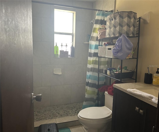 bathroom featuring vanity, tile patterned flooring, curtained shower, and toilet