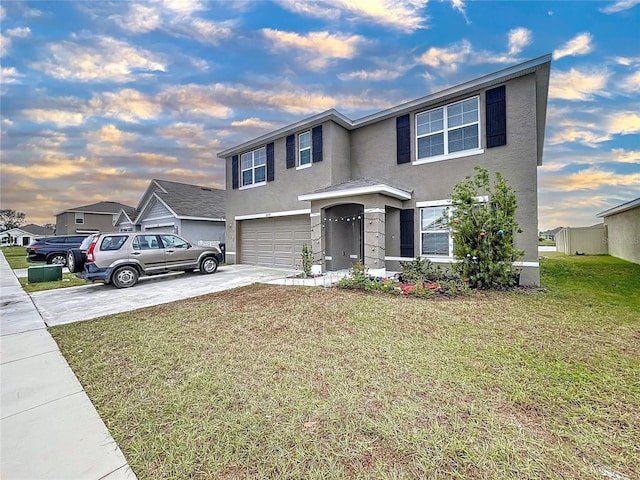 view of front of property featuring a yard and a garage