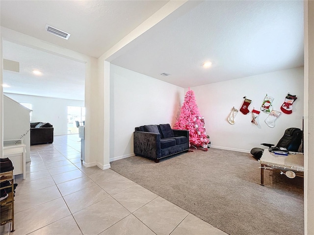 living area featuring light carpet