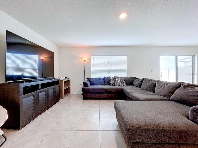 living room featuring plenty of natural light and light tile patterned floors